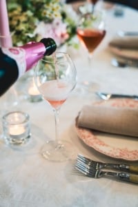 Autumn floral arrangement with candles on a table, complementing seasonal dinner table setup