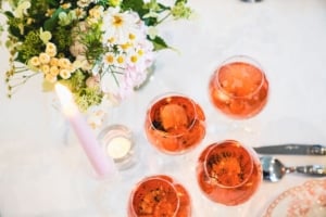 Champagne poured into tulip glasses at an autumn dinner party, ready to welcome guests