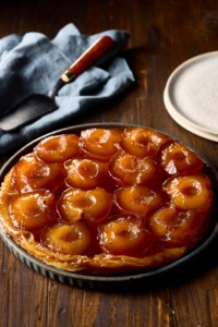 French Tarte Tatin with caramelised apples and golden pastry served on a plate for Thanksgiving dessert.